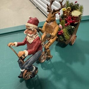 Santa and Reindeer Biking Holiday Figurine really moves